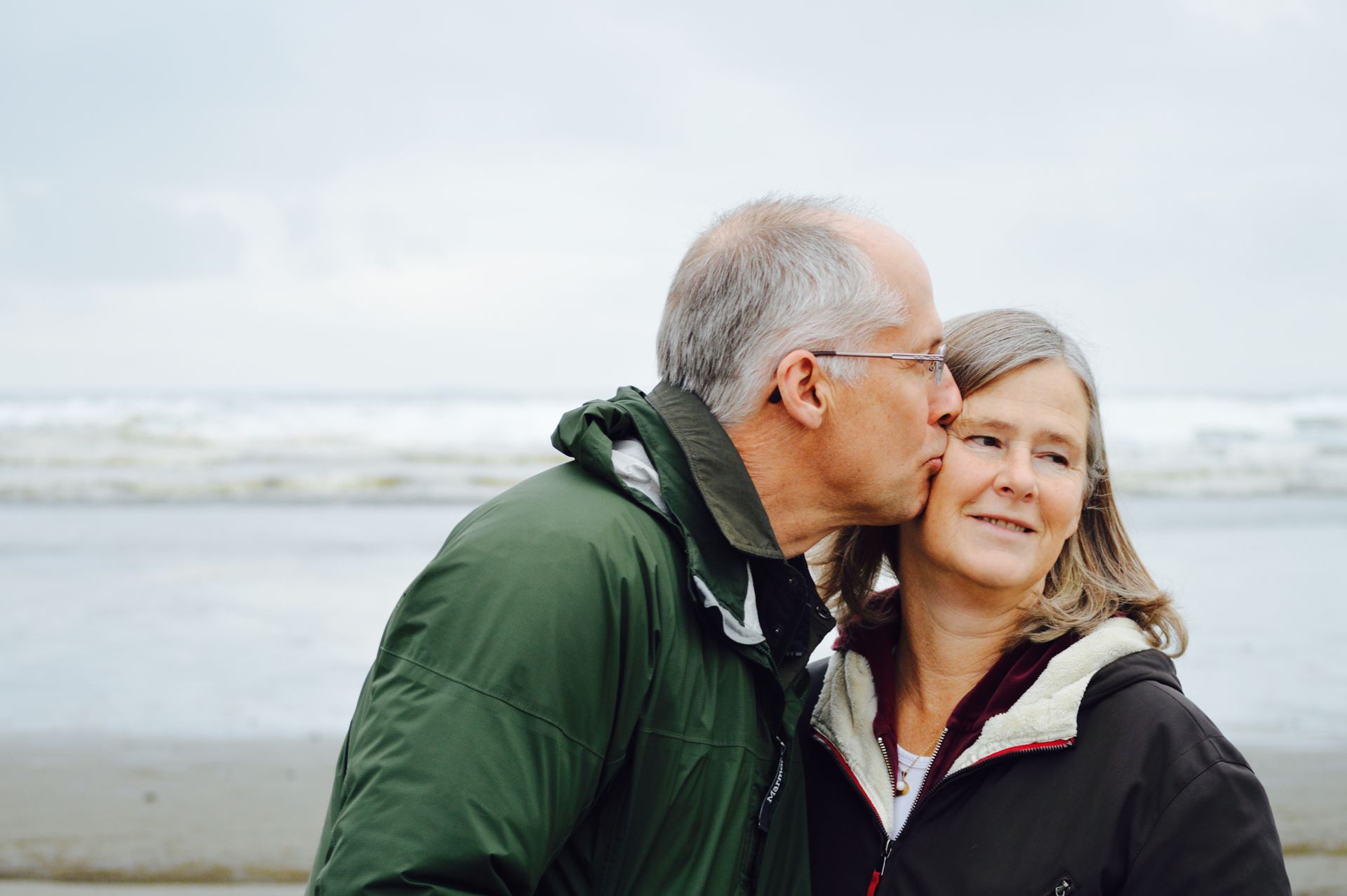 a man and a woman standing next to a body of water